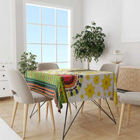 Tablecloth covering rectangular table: green banding, yellow flowers, red-and-black trim