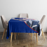 Blue tablecloth with patriotic emblem print across the center of dining table