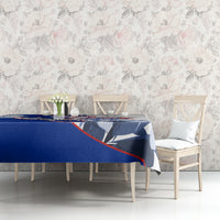 Blue tablecloth with patriotic print on dining table, styled with chairs