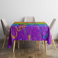 Rainbow glitter pride tablecloth over rectangular table with colorful center pattern
