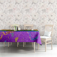 Rainbow glitter pride tablecloth over long table with colorful rainbow print and party shapes