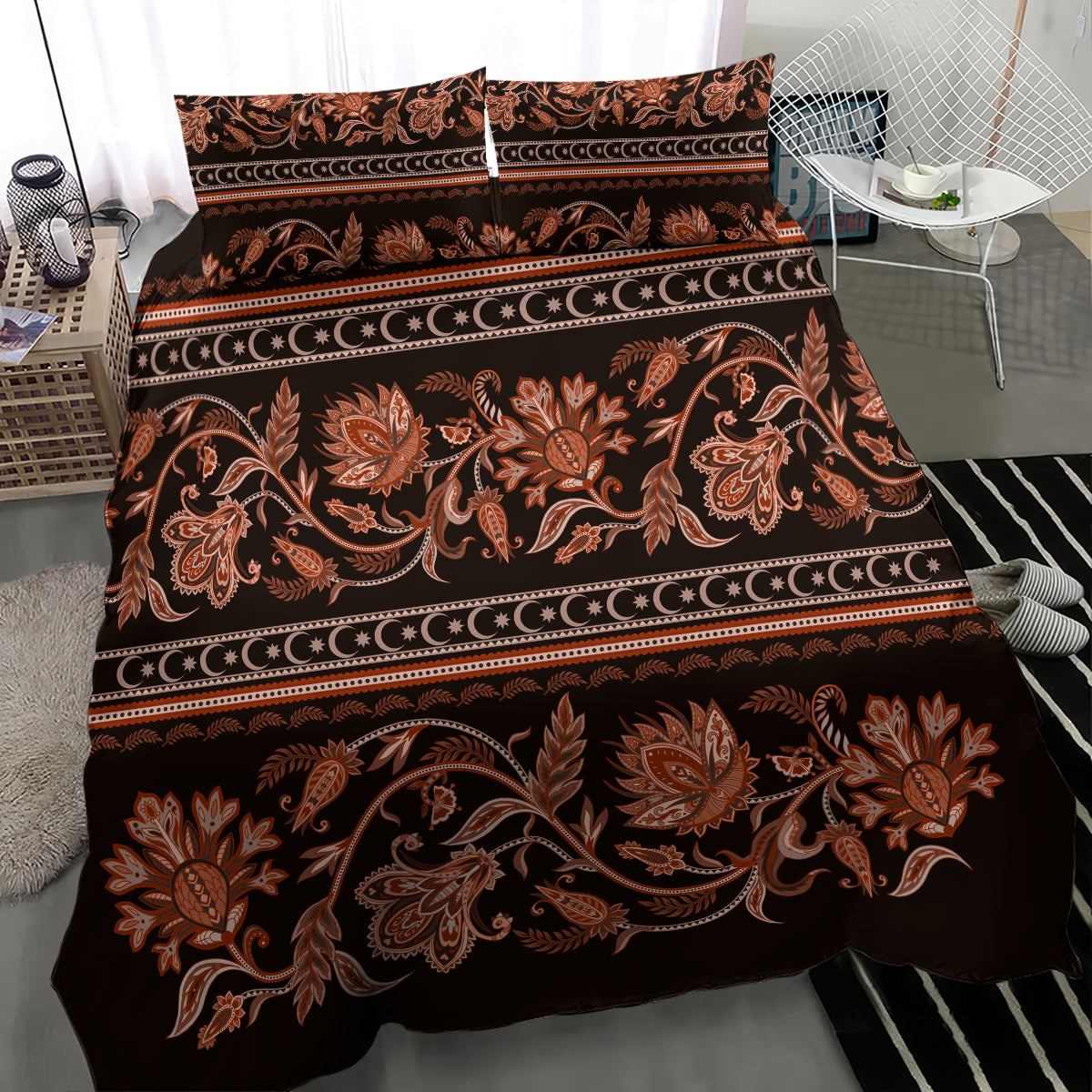 Dark brown bedding set with orange floral buta ornament and striped banding, flat lay