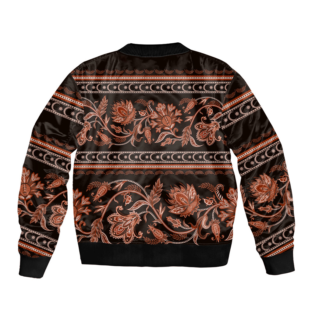 Dark unisex bomber jacket with gold-orange floral buta motifs and ribbed hem cuffs