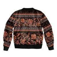 Dark unisex bomber jacket with gold-orange floral buta motifs and ribbed hem cuffs