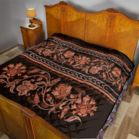 Black bed quilt with orange floral scroll pattern, striped trim, and quilted diamond stitching