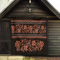 Black wall-hanging quilt with orange floral buta pattern, stitched quilt blocks, and bands