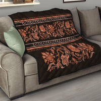 Black sofa quilt with orange floral scroll pattern and border stripes, quilted diamond texture