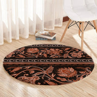 Round traditional carpet with dark center and orange floral ornament print around the edge