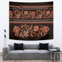 Large hanging tapestry featuring orange floral scrollwork on dark background, gold bands