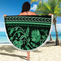 Green circular beach blanket with tassel fringe, ornate flower and vine motif