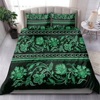 Green bedding set with matching pillow shams, bold floral vines and stripe ornament