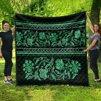 Green quilt with quilted texture, border stripes, and ornate floral ornament print