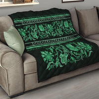 Green quilt draped on sofa with ornate floral ornament print and striped border