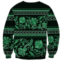 Unisex crewneck sweatshirt with dark base and bold green floral ornamental print across chest