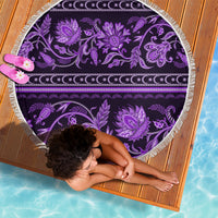 Violet round beach blanket with purple decorative flowers and white fringed border