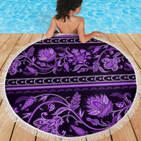 Round violet beach blanket with purple floral ornamental design and white fringed rim