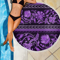 Violet round beach blanket with purple floral ornament print and white fringed hem