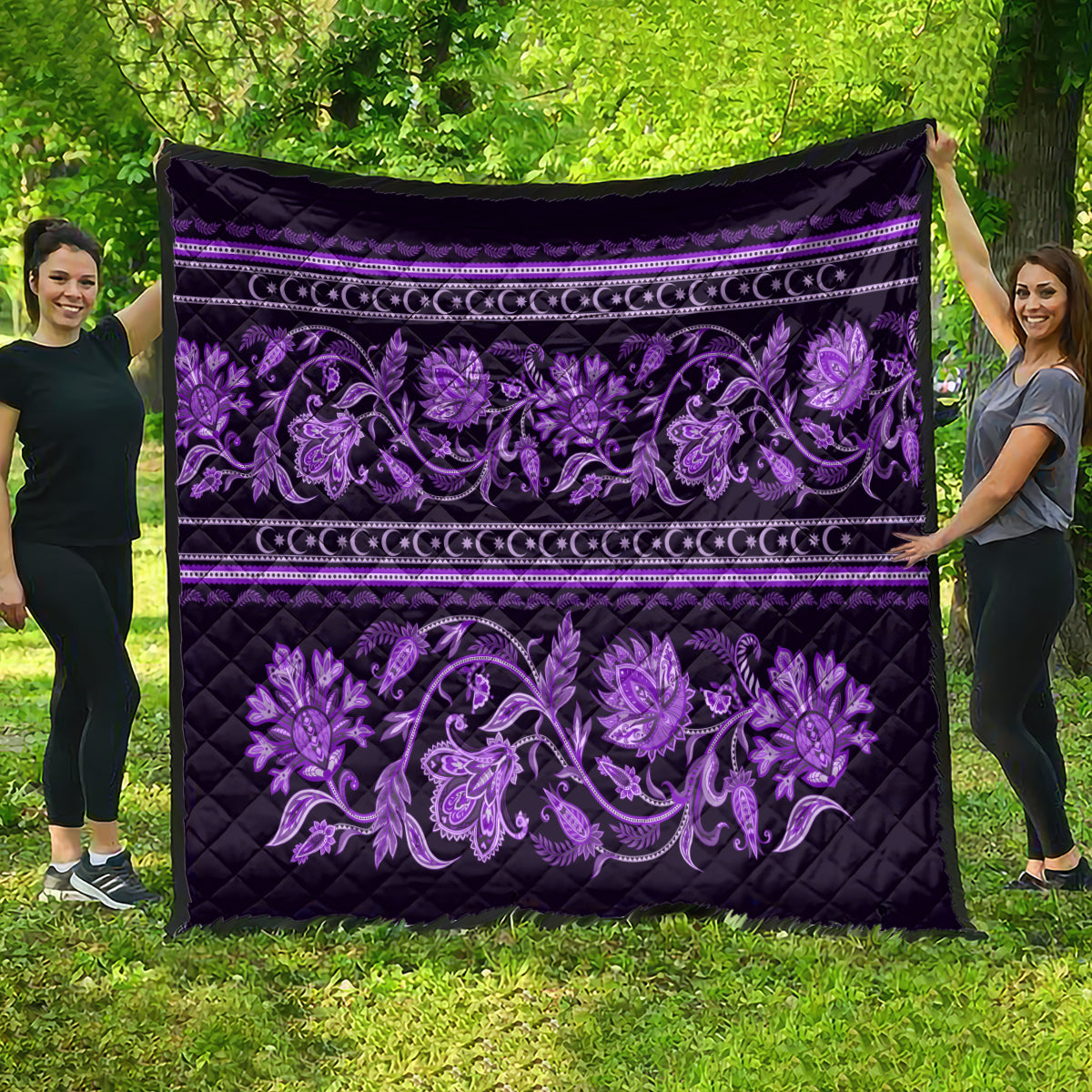 Violet quilt laid out flat, featuring purple floral buta motifs and striped border bands