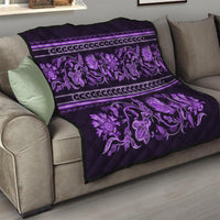 Violet quilt draped over a sofa, featuring purple floral buta motifs and striped border