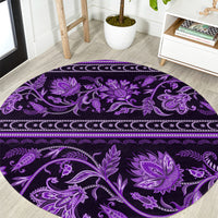 Violet round carpet with ornate floral and paisley pattern, decorative border band