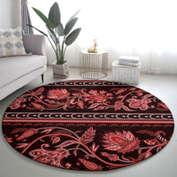 Round red ornamental carpet with floral medallions and striped border