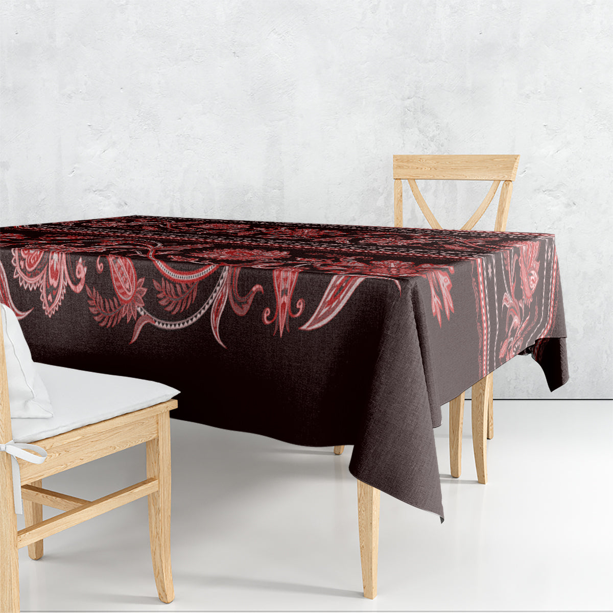 Dark red and black traditional tablecloth with red floral ornaments and draped corner