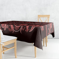 Dark red and black traditional tablecloth with red floral ornaments and draped corner