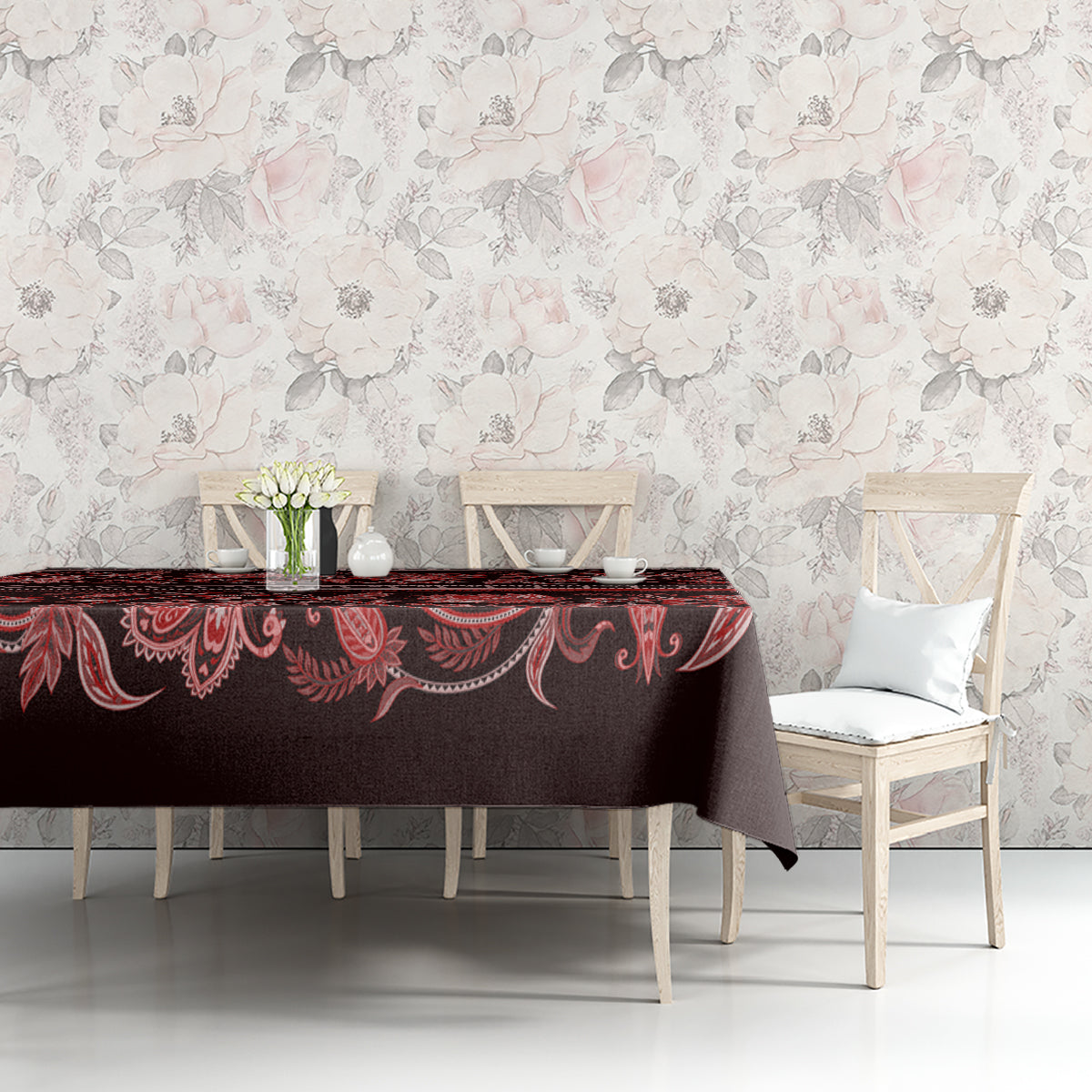 Traditional patterned tablecloth with dark background and red floral motifs on table