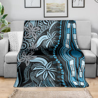 Blue dashiki-pattern blanket draped on sofa, featuring striped border and leaf medallions