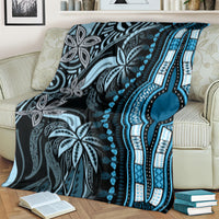 Blue and black dashiki-pattern blanket covering sofa, showing vertical teardrop motif