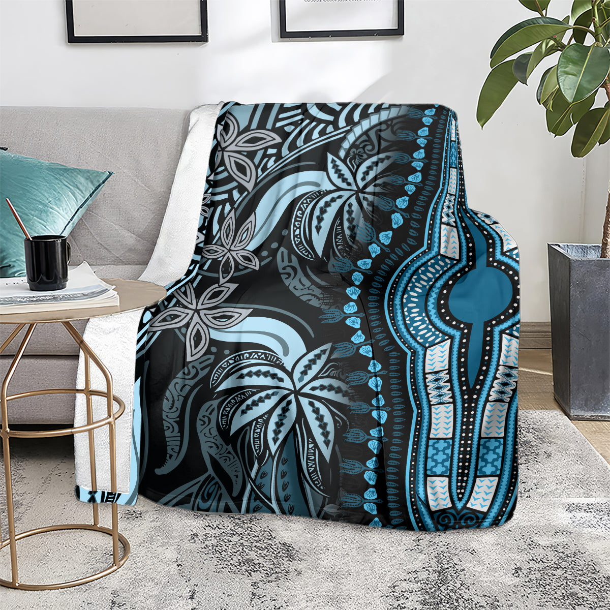 Blue and dark gray dashiki-pattern blanket folded on couch, with geometric border stripe