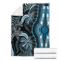 Folded blue dashiki-pattern blanket with ornate leaf motifs and vertical stripe border