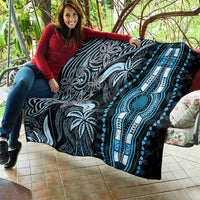 Black and blue dashiki-style quilt draped with bright blue pendant centerpiece and motifs