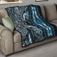 Black and blue dashiki quilt folded on sofa, showing central arched pendant design