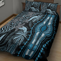 Blue quilt bed set laid on bed with two patterned pillow shams and coordinating duvet
