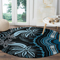 Round blue dashiki-style carpet with black-and-white floral medallions and teal accents