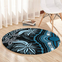 Round blue dashiki-style carpet on wood floor with black, white, and teal medallion pattern