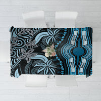 Blue and black patterned tablecloth with bold tribal-style motifs and central floral accent