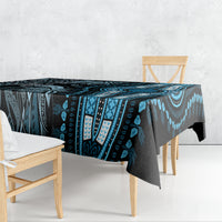 Blue and black patterned tablecloth draped over dining table, tribal stripes and motifs