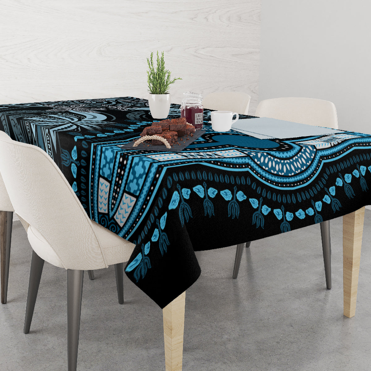 Blue and black patterned tablecloth on dining table with matching tribal border design