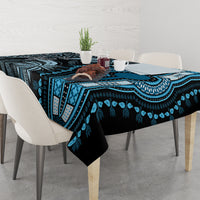 Blue and black patterned tablecloth on dining table with matching tribal border design
