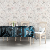 Blue and black patterned tablecloth on table with tribal medallion designs and leaf accents