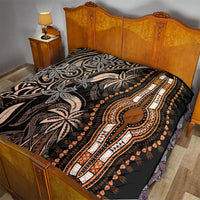 Dark dashiki quilt on bed with gold center medallion, beige motifs, and quilted texture