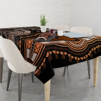 Rectangular tablecloth draped on tabletop; dark base with gold and geometric motifs