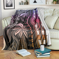 Pastel dashiki pattern blanket on bedspread, black base with purple pink and gold trim