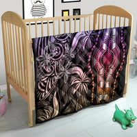 Dashiki-inspired quilt on a crib, black with purple/pink/orange medallion motif