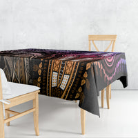 Patterned tablecloth draped over dining table edge, purple and black tribal design.