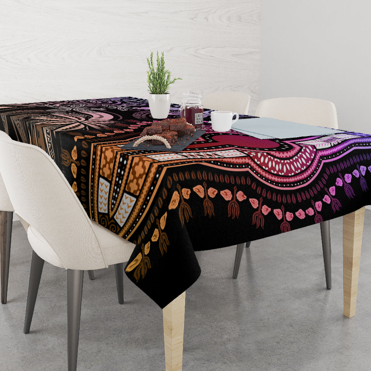 Patterned tablecloth across dining table with purple, black, and gold motif borders.