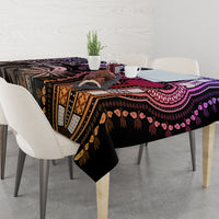 Patterned tablecloth across dining table with purple, black, and gold motif borders.