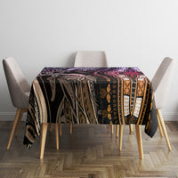 Rectangular patterned tablecloth with purple floral and cross-like medallion center.